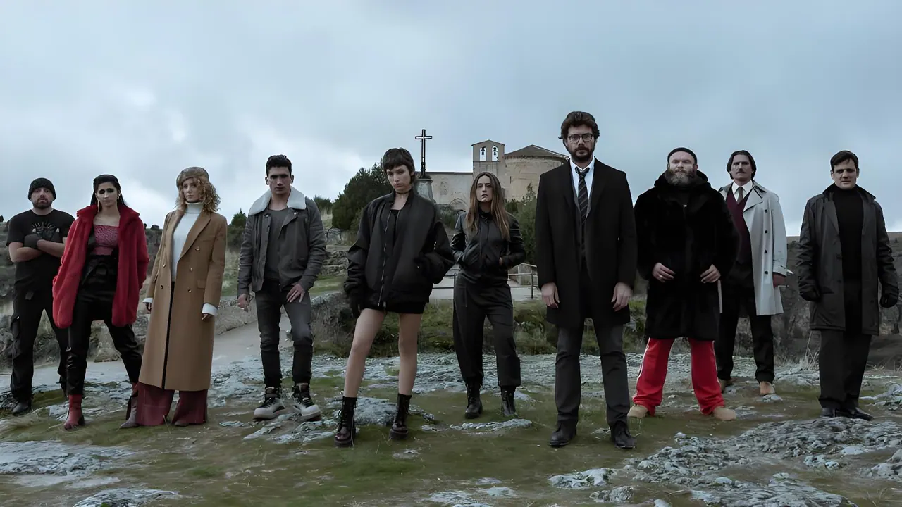 The ensemble of Money Heist standing in a wide outdoor formation.